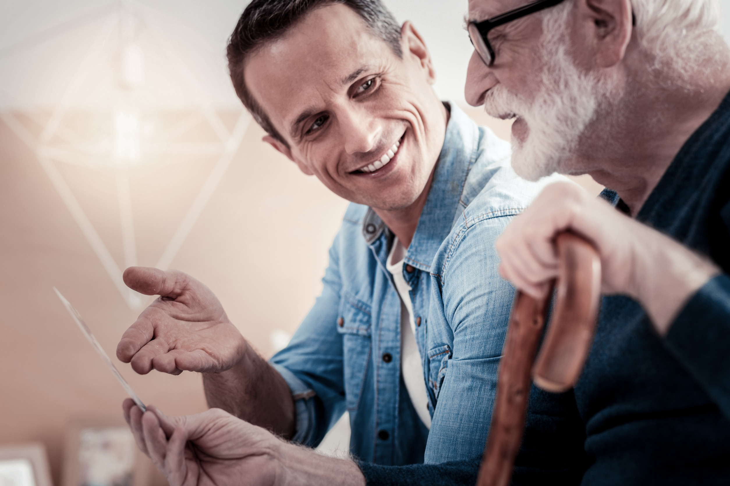 Delighted positive father and son talking about past